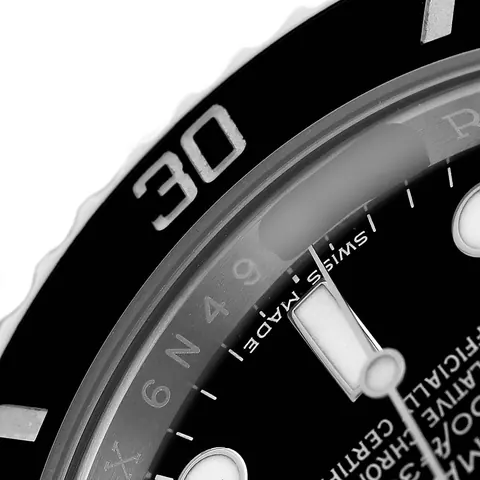 Macro view of dial printing and bezel markers on a Rolex Submariner